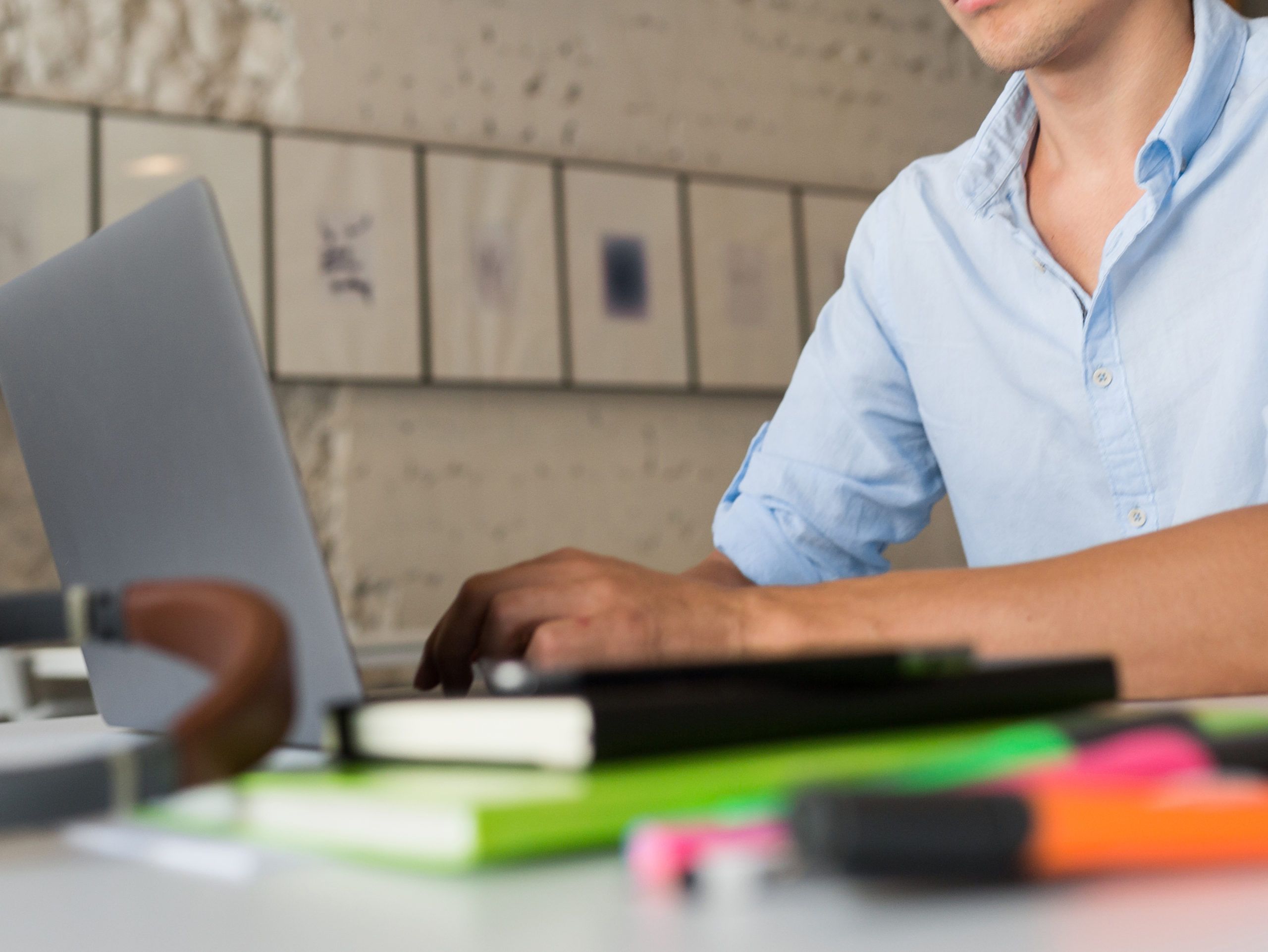 busy online remote worker young confident man working on laptop, sitting in co-working office, freelance job, typing